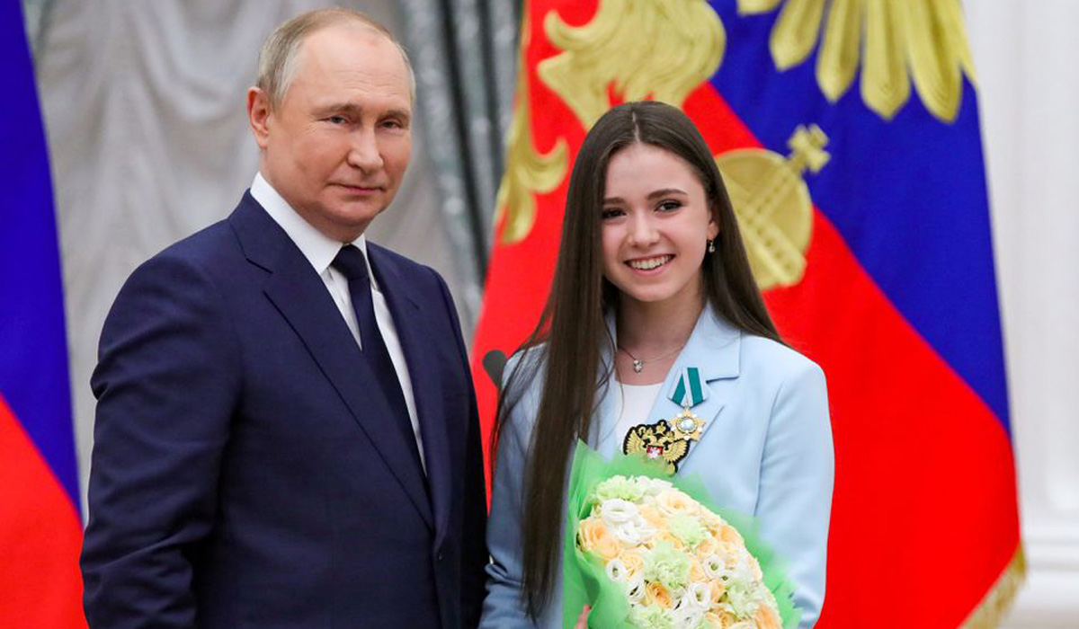 Russian President Vladimir Putin poses for a picture with figure skater Kamila Valieva